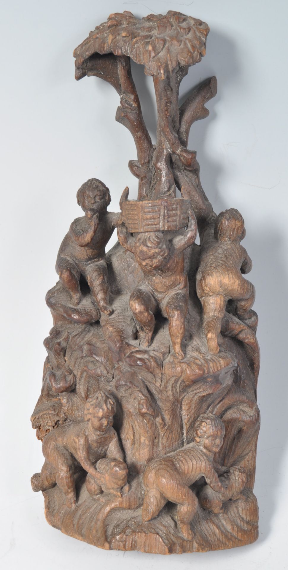 EARLY 18TH CENTURY CARVED FIGURINE GROUP OF CHERUBS CLIMBING TREE