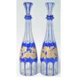 PAIR OF 19TH CENTURY BLUE AND WHITE GILT OVERLAY DECANTERS