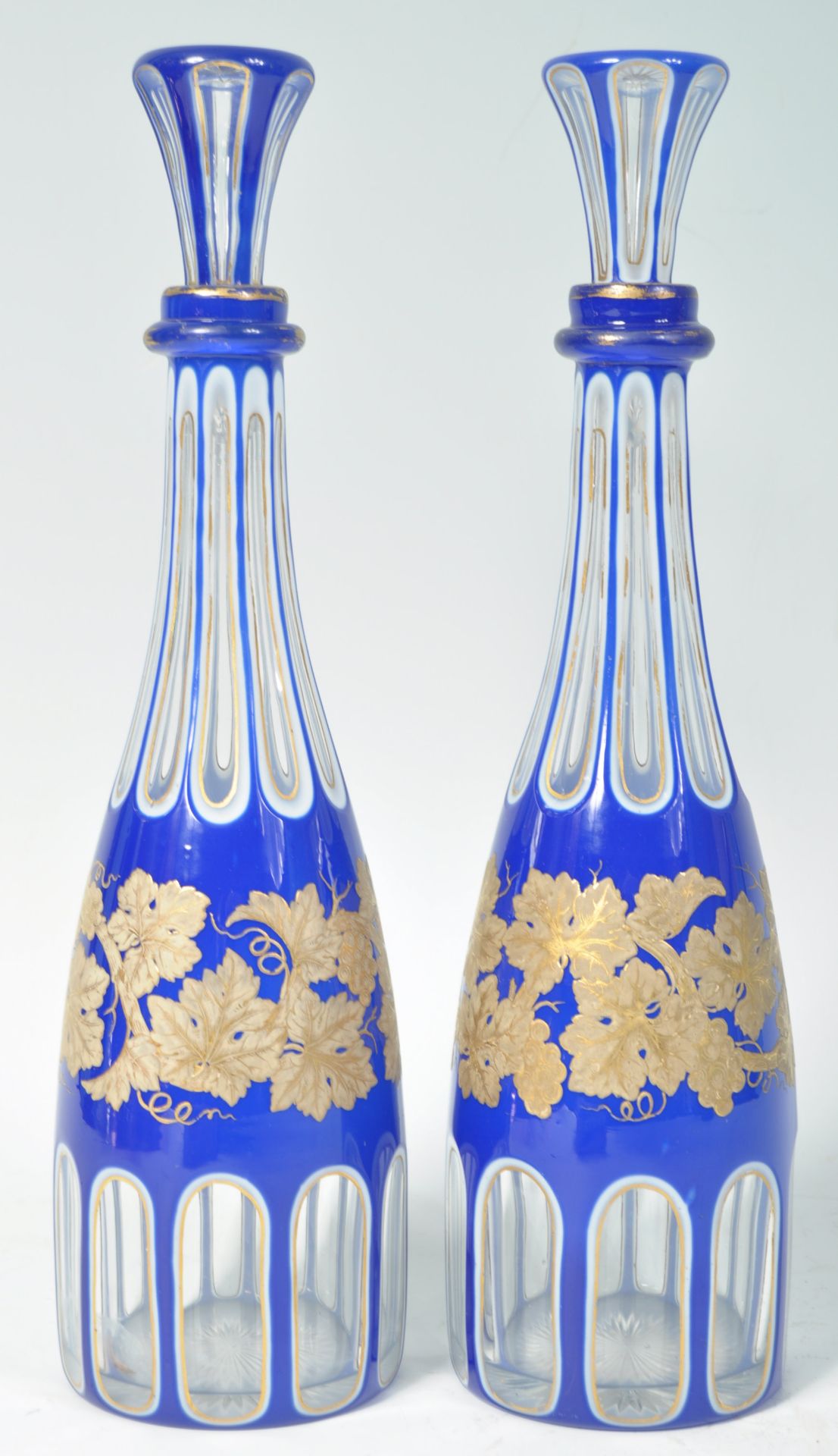 PAIR OF 19TH CENTURY BLUE AND WHITE GILT OVERLAY DECANTERS