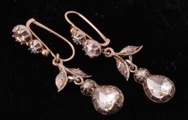 A pair of Georgian diamond earrings. The earrings strung with large rose pear and round shaped