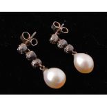 A pair of 19th century white metal pearl and diamond drop earrings. The earrings  strung with a