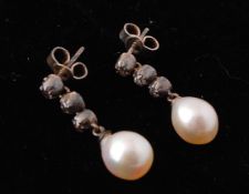 A pair of 19th century white metal pearl and diamond drop earrings. The earrings  strung with a