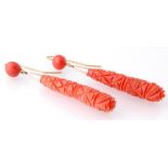 A pair of early 19th century coral drop earrings. The earring having large drops carved with