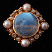 An Edwardian intaglio diamond moonstone and pearl brooch pin. The pin set with a central intaglio