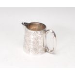 An 1987 Victorian silver hallmarked creamer mug with chase decorated design having c-scroll