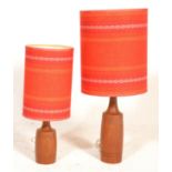 A pair of mid century West German table lamps with tall cylindrical shades having red banded