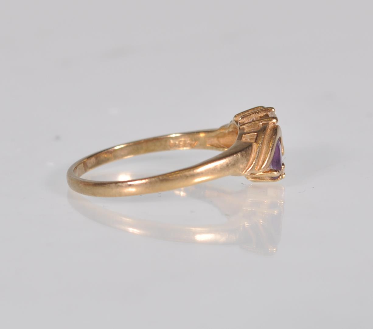 An English hallmarked 9ct yellow gold ladies dress ring set with two teardrop purple stones with two - Image 3 of 7