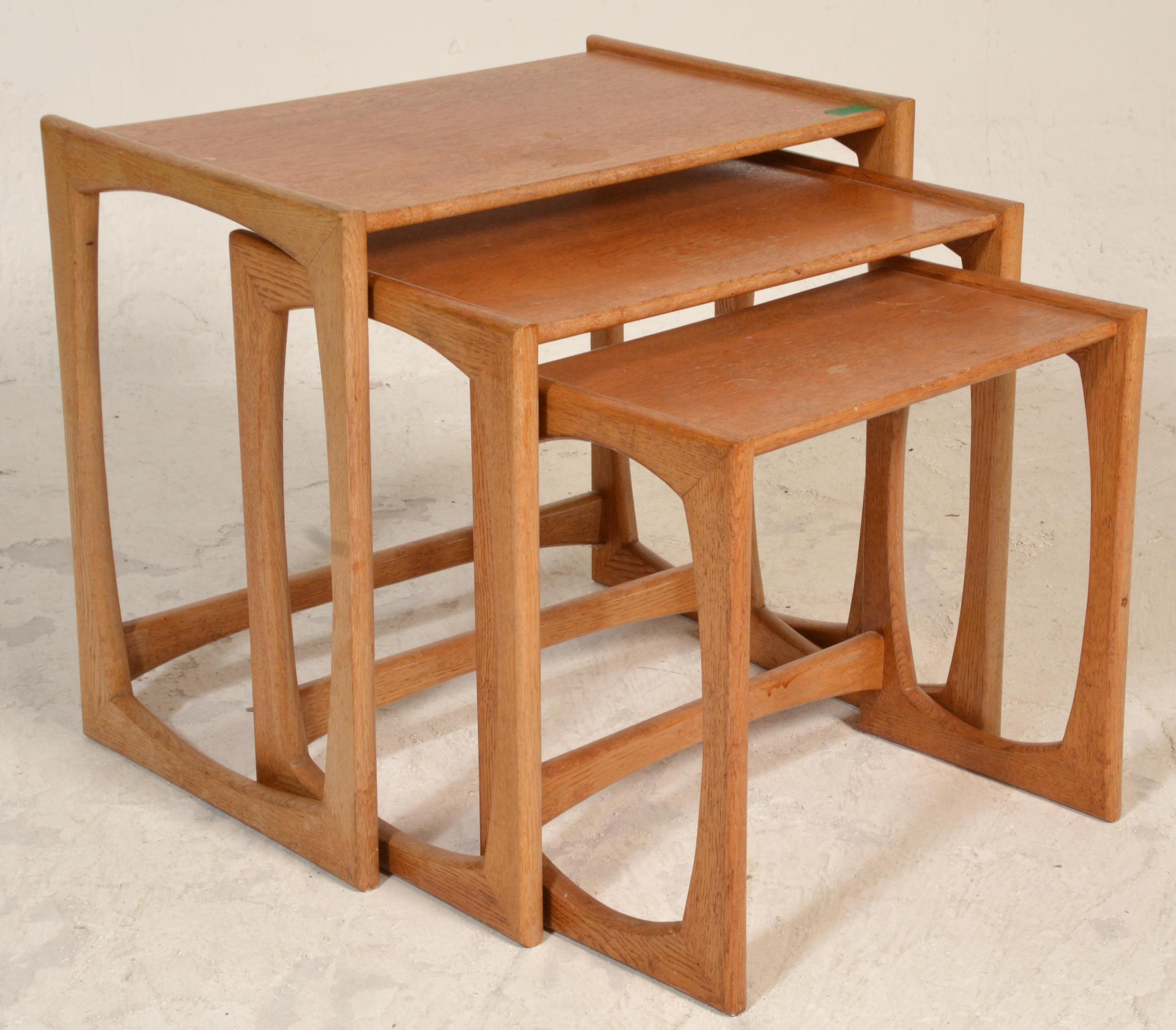 A 1970's G-Plan oak quadrille pattern nest of tables being raised on squared legs with shaped - Image 5 of 5