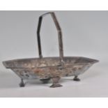 An antique silver plated basket of chamfered rectangular form having repousse decoration with an