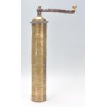 A good early 20th Century Middle Eastern brass coffee grinder of cylindrical form having opening