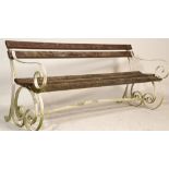 A 19th century / early 20th century strap work cast iron and wooden garden bench. The painted