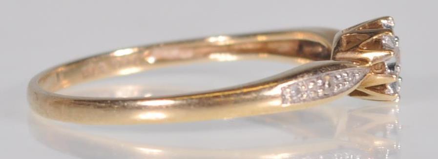 A hallmarked 9ct yellow gold ladies ring having a central round cut diamond set within a starlike - Image 3 of 7