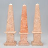 A group of three antique neoclassical carved pink marble obelisk mantelpiece ornaments, each bing