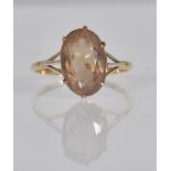 A 9ct gold ladies dress ring set with a large oval facet cut smoky quartz. Stamped 9ct. Weight 3.3g.