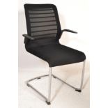 A contemporary designer chrome cantilever side / desk chair having a fabric mesh seat with