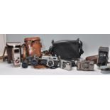 A mixed collection of vintage 20th cameras and film cameras to include a leather cased Bell & Howell
