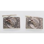 A pair of sterling silver cufflinks embossed with images of an eagles head. Gross weight 13.7 grams.