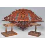 A vintage 20th Century decorative oak wall hanging pipe rack with carved and engraved leaf