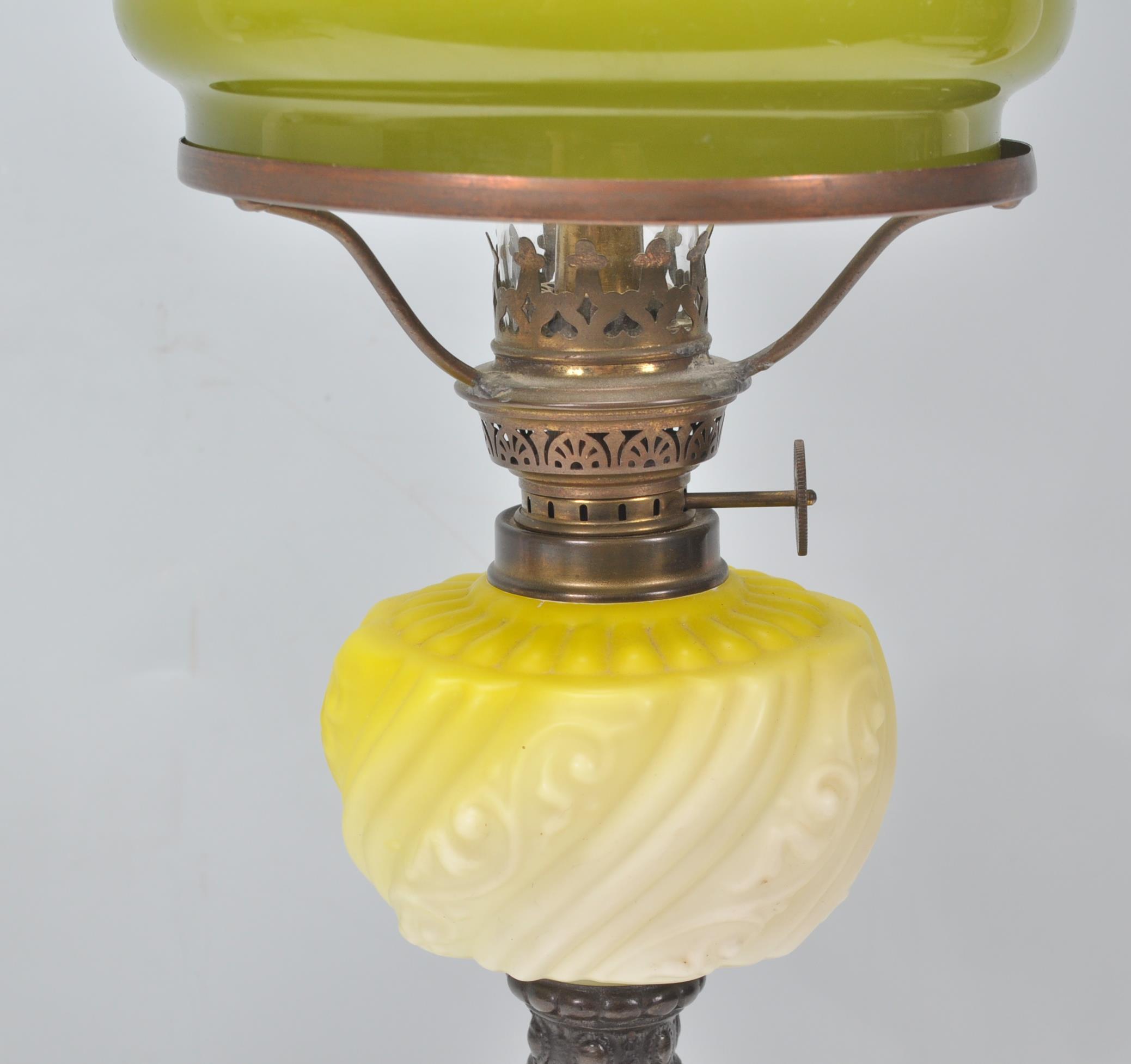 A 19th Century Victorian oil lamp of small proportions being raised on a square stepped base - Image 4 of 6