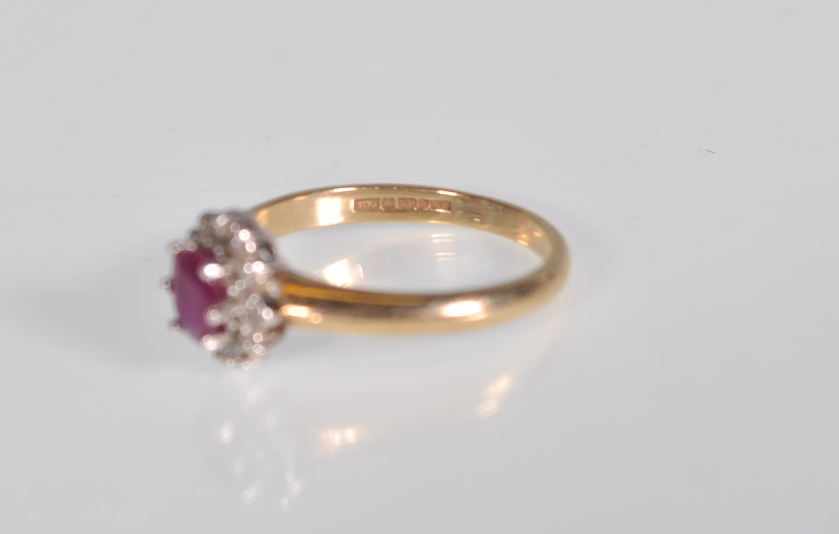 A hallmarked 9ct gold diamond and garnet flower head ring having a central faceted red stone with - Image 6 of 6