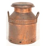 An early 20th century Industrial metal copper milk churn. The churn of smaller proportions