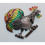 An sterling silver plique a jour rooster brooch with blister pearl body and marcasite decoration.