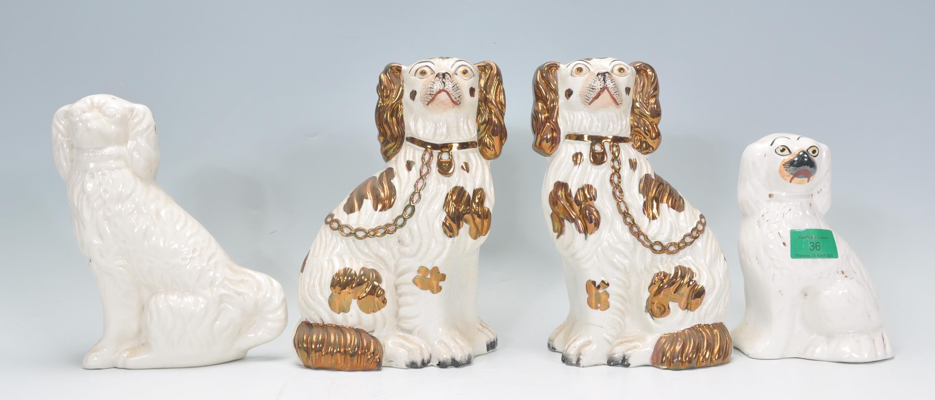 A group of four 19th Century Victorian fire side staffordshire dogs to include two large and two