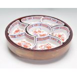 A 20th Century Chinese famille rose Lazy Susan hor d'oeuvres set consisting of seven fitted dished