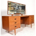 A mid century retro Austinsuite teak wood dressing table and chest of drawers being raised on