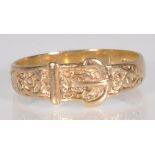 A hallmarked 9ct yellow gold buckle ring with engraved floral decoration. Hallmarked 375 for