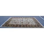 A large Persian / Islamic floor rug of beige ground with large floral medallion centre, spandrels to