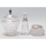 A group of three cut glass and silver items to include a jam pot having a silver hallmarked lid with