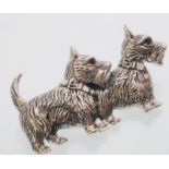 A sterling silver brooch in the form of a pair of Scottish Terriers with red stones set as eyes.