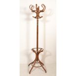 A vintage 20th century mahogany Thonet style bentwood hat stand being raised on splayed legs with