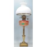 A 19th Century Victorian antique oil lamp raised on a square stepped base with a reeded column