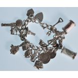 A good vintage 20th Century silver hallmarked charm bracelet adorned with many charms to include a