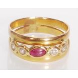 A stamped 750 18ct gold ring having a split band set with a marquise ruby cabochon flanked by four