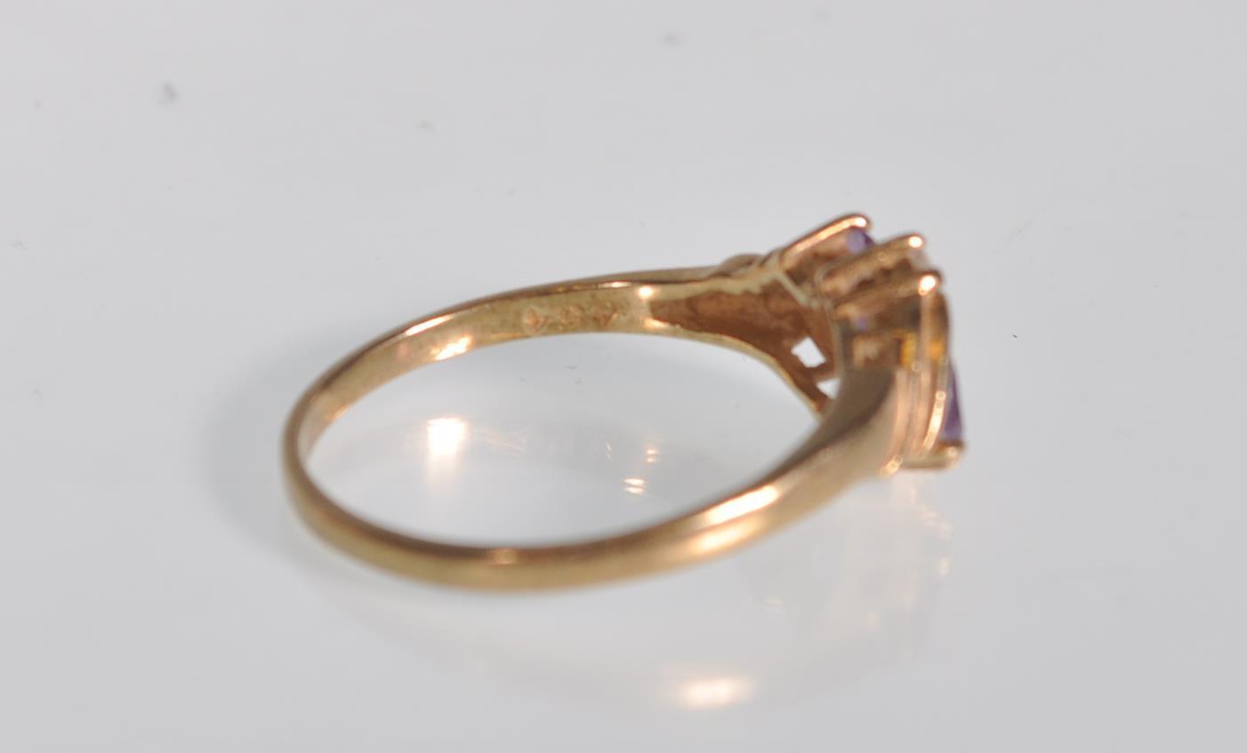 An English hallmarked 9ct yellow gold ladies dress ring set with two teardrop purple stones with two - Image 7 of 7