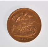 A Victorian 1897 22ct gold half sovereign coin having a George and the Dragon design with an old