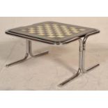 A retro mid 20th Century chrome framed coffee table with inset black and white painted chess board