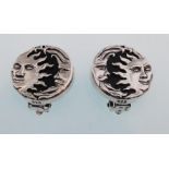 A pair of sterling silver and natural onyx clip on earrings decorated with a celestial "Moon and