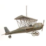 A vintage 20th Century tin model of a propelling Biplane finished in grey with hanging hook atop.