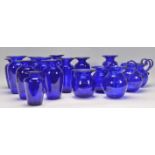 A group of 16 Bristol Blue glass vases of small proportions and varying shapes and sizes including