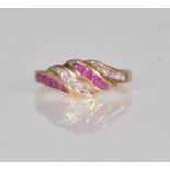 A hallmarked 9ct gold red and white stone set ring having bands of flush set red and white stones.