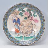 An early 19th Century Chinese charger plate with hand painted and enameled central scene depicting a