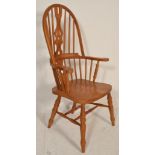 A Victorian style pine Windsor chair being raised on turned legs with saddle seat, pierced and