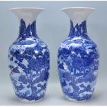 A matching pair of 19th Century Japanese Arita blue and white vases of baluster form and flared