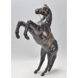 An unusual 20th century leather marley horse sculpture being set in a raised motion with good