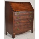 A 19th century George III mahogany and ebony line inlaid bureau desk. Raised on bracket feet