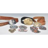 A collection of belt buckles mostly American influence to include American Flag, Cheyenne and Harley